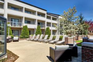 a row of chairs in front of a building at Courtyard Rochester Brighton in Rochester