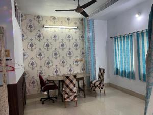 a dining room with a table and chairs at Peaceful Living in Kolkata