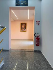 a hallway with a painting on the wall and a fire hydrant at Kanaj Rooms and Apartments in Vlorë