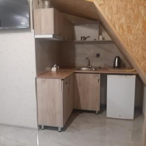 a kitchen with wooden cabinets and a sink at Noy in Goris