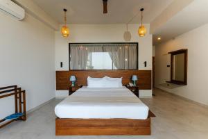a bedroom with a large bed and two lamps at Ivory Resort Dikwella in Dickwella +126 photos