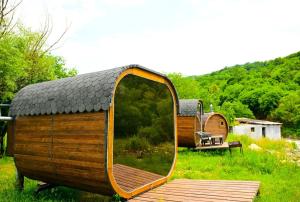 a small wooden house with a mirror in a field at Loft Dilijan in Dilijan