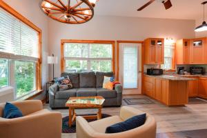 a living room with a couch and a table at Private Dock & Deck: Tranquil Dam Pond Cottage! in Augusta +25 photos