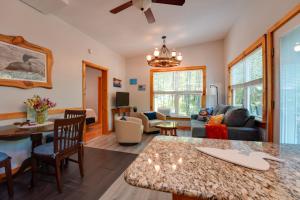 a living room with a couch and a table at Private Dock & Deck: Tranquil Dam Pond Cottage! in Augusta