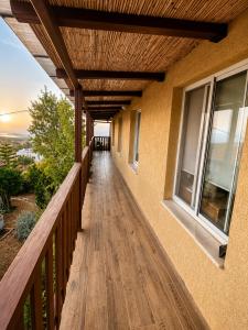 a balcony with a wooden walkway on a house at la noach in Metulla