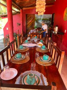 a long wooden table with plates and dishes on it at Point lanabarra in Amontada +56 photos
