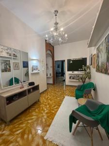 a living room with a wooden floor and a television at Sister House in Cerignola