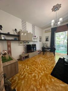 a living room with a wooden floor and a dining room at Sister House in Cerignola