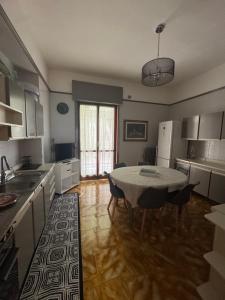 a kitchen with a table and chairs in a kitchen at Sister House in Cerignola +17 photos