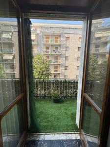 a window view of a yard with a building at Sister House in Cerignola
