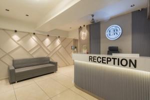 a reception area of a hospital with a reception desk at Hotel Lavish Regency in Ahmedabad