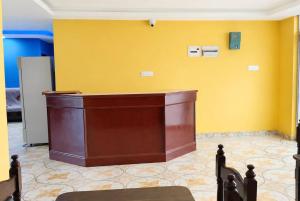 a courtroom with a podium in front of a yellow wall at Niru Buddha Hotel, Lumbini in Rummindei