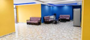 a waiting room with purple chairs and a table at Niru Buddha Hotel, Lumbini in Rummindei