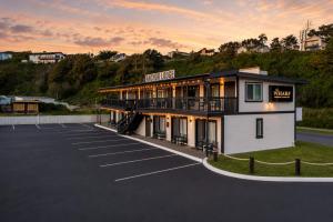 a building in a parking lot with a lot at Anchor Lodge in Fort Bragg