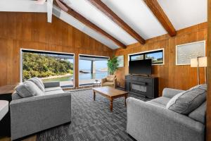 a living room with two couches and a tv at Anchor Lodge in Fort Bragg