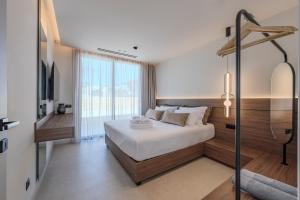 a bedroom with a bed and a large window at Nysa Luxury villas 3-4-5-6 in Heraklion +61 photos