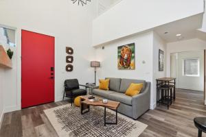 a living room with a couch and a red door at Quarry A21 in Whitefish