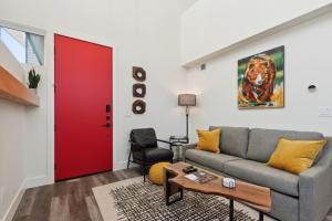 a living room with a couch and a red door at Quarry A21 in Whitefish