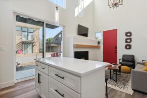 a kitchen with a white counter and a living room at Quarry A21 in Whitefish