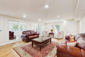 a living room with leather furniture and a coffee table at Pond Treasure in Sandwich