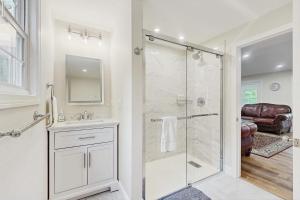 a bathroom with a shower with a glass door at Pond Treasure in Sandwich