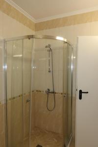 a shower with a glass door in a bathroom at goldenseaview apartment 2 in Pomorie +101 photos