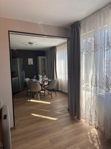 a dining room with a table and chairs and a mirror at Casmere Suite in Pomorie