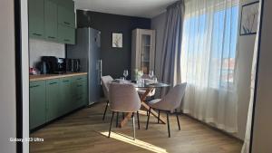 a kitchen with a table and chairs in a kitchen at Casmere Suite in Pomorie