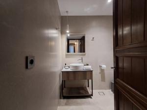 a bathroom with a sink and a mirror at Nykteri Heritage House Olympus & Sea View in Palaios Panteleimonas