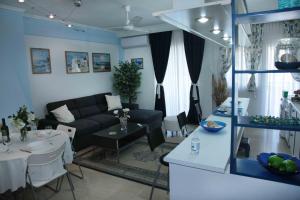 a living room with a couch and a table at Hellas Dream in Perea