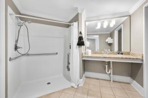 a bathroom with a shower and a sink at Bask Hotel at Big Rock Landing in Morehead City +45 photos