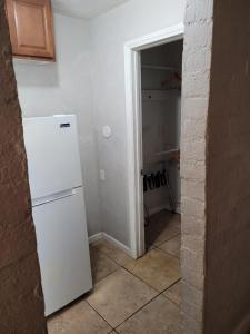 a kitchen with a white refrigerator in a room at Sterling Gardens in Las Vegas