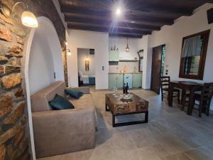 a living room with a couch and a table at Nykteri Heritage House Olympus & Sea View in Palaios Panteleimonas +29 photos