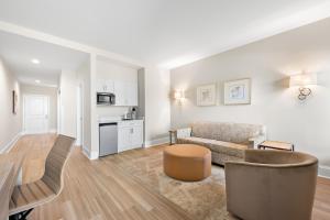 a living room with a couch and a kitchen at Bask Hotel at Big Rock Landing in Morehead City