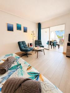 a bedroom with a bed and a living room at Reflet Marin - Studio Village Soleil in Le Gosier