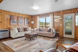 a living room with a couch and a table at Pondside Lodge BHBungalows #5 in Custer