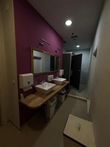 a bathroom with two sinks and a purple wall at Boutique Central Square Hostel in Trogir +26 photos