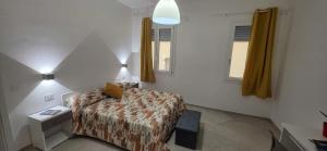 a bedroom with a bed and a table and a window at Bardia Guest House in Dorgali +14 photos