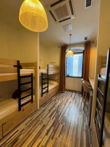 a room with three bunk beds and a window at Boutique Central Square Hostel in Trogir