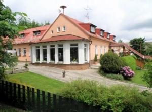 a house with a fence in front of it at Apartmán Penzion Sigma in Dolní Žďár