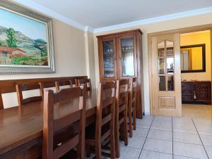 a dining room with a wooden table and chairs at Fuenteazul in Hortigüela