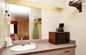 a bathroom with a sink and a mirror at Red Roof Inn Lompoc in Lompoc +17 photos