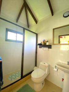 a bathroom with a toilet and a sink at Cabañas Keihana Rapa Nui in Hanga Roa +24 photos