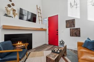 a living room with a fireplace and a red door at Quarry A35 in Whitefish