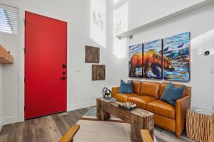 a living room with a couch and a red door at Quarry A35 in Whitefish