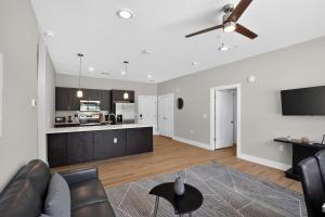 a living room with a couch and a ceiling fan at Parkview Greer 2BR Retreat in Greer