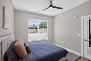 a bedroom with a bed and a window at Parkview Greer 2BR Retreat in Greer