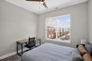 a bedroom with a bed and a desk and a window at Parkview Greer 2BR Getaway in Greer