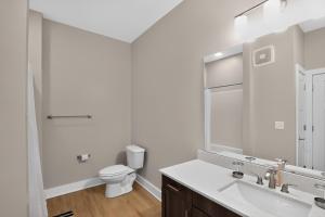 a white bathroom with a sink and a toilet at Homey 2BR with Great Space in Greer +13 photos