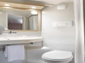 a white bathroom with a toilet and a sink at Premiere Classe Saint Quentin in Saint-Quentin +27 photos